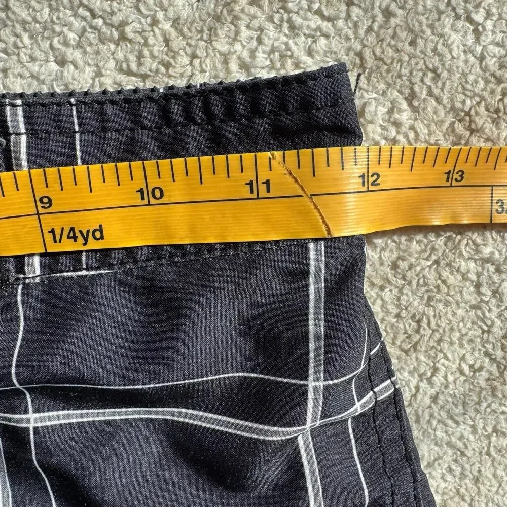 Quiksilver Board Shorts Featuring a Black and White Plaid Design